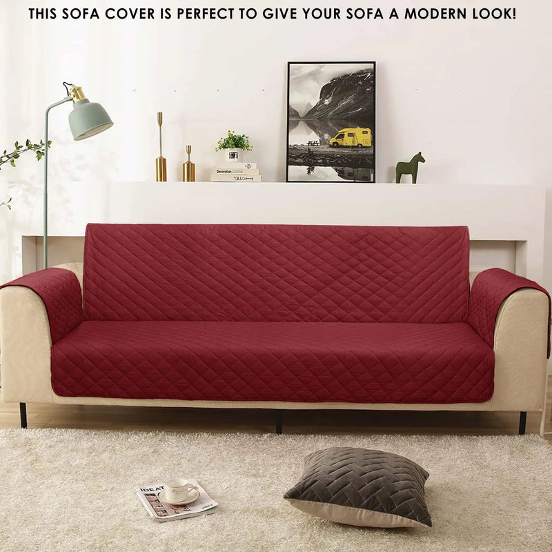 A red and beige sofa cover with a quilted design in a living room setting