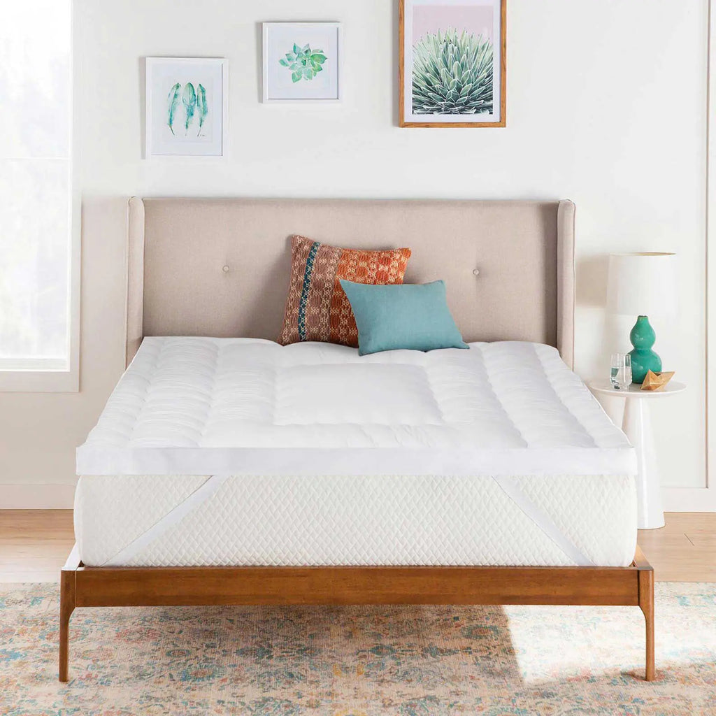 A mattress topper on a bed with pillows